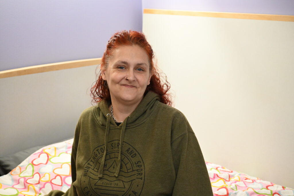 Catelyn sits in her bed at Deborah's Place