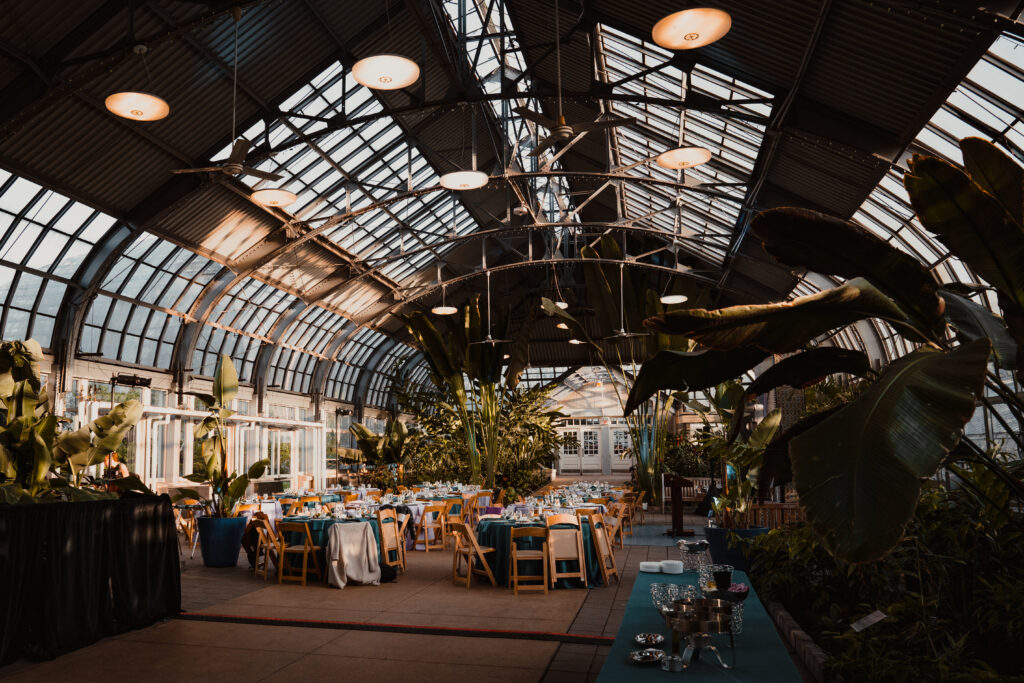 Tables and chairs set in the Garfield Park Conservatory's Horticulture Hall, the venue for Deborah's Place's 2023 fundraising event.